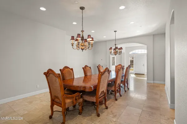 a dining room with furniture and a chandelier