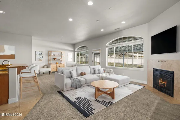 a view of an empty room with a fireplace and a window