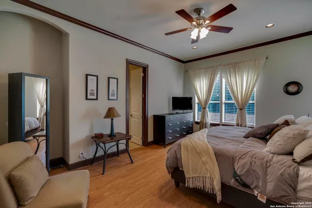 a spacious bedroom with a bed and a chandelier