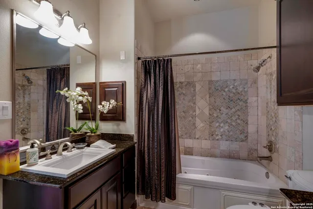a bathroom with a tub sink and mirror