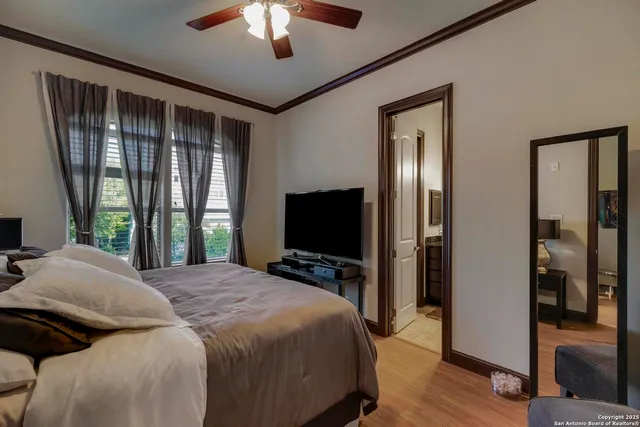 a bedroom with a large bed and a flat tv screen