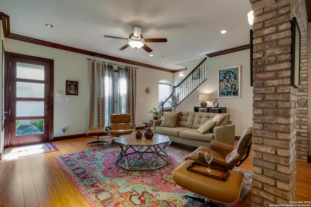 a living room with furniture and wooden floor