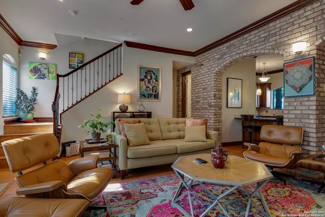 a living room with furniture and a chandelier