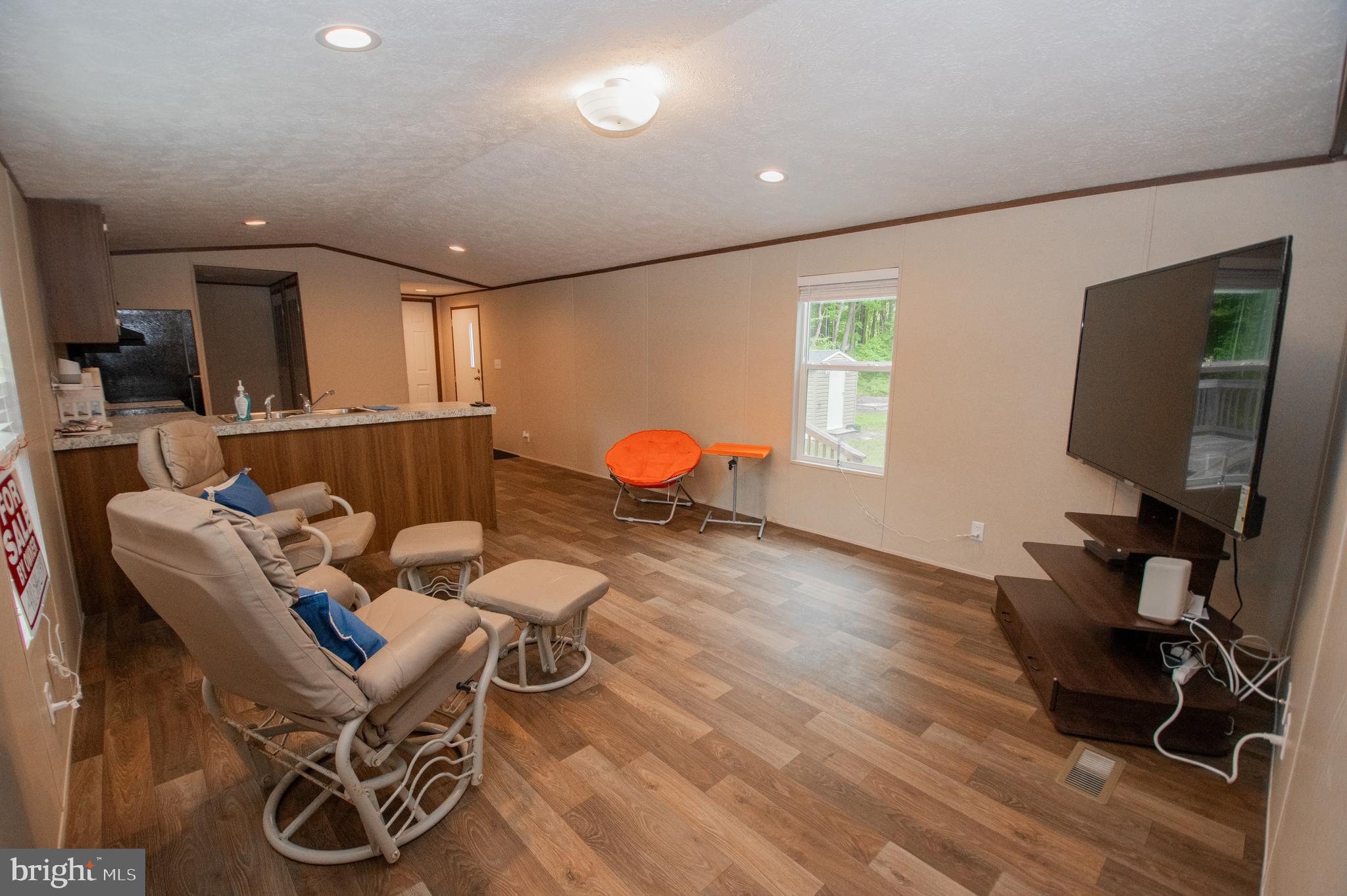 21449 Nanticoke Road Tyaskin, MD 21865 - Photo 5 of 14 a living room with furniture and a flat screen tv