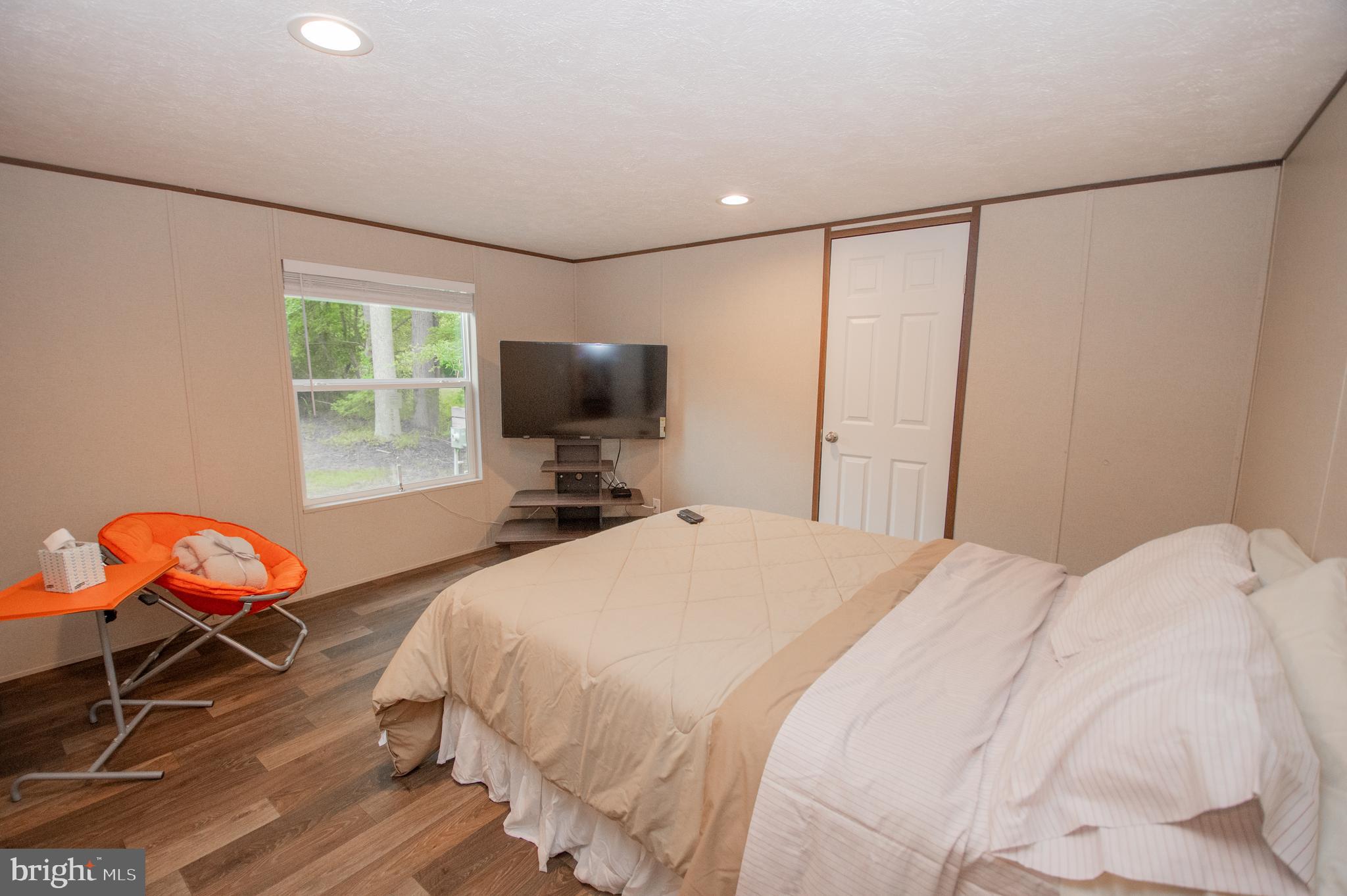 21449 Nanticoke Road Tyaskin, MD 21865 - Photo 6 of 14 a bedroom with a bed tv and a window
