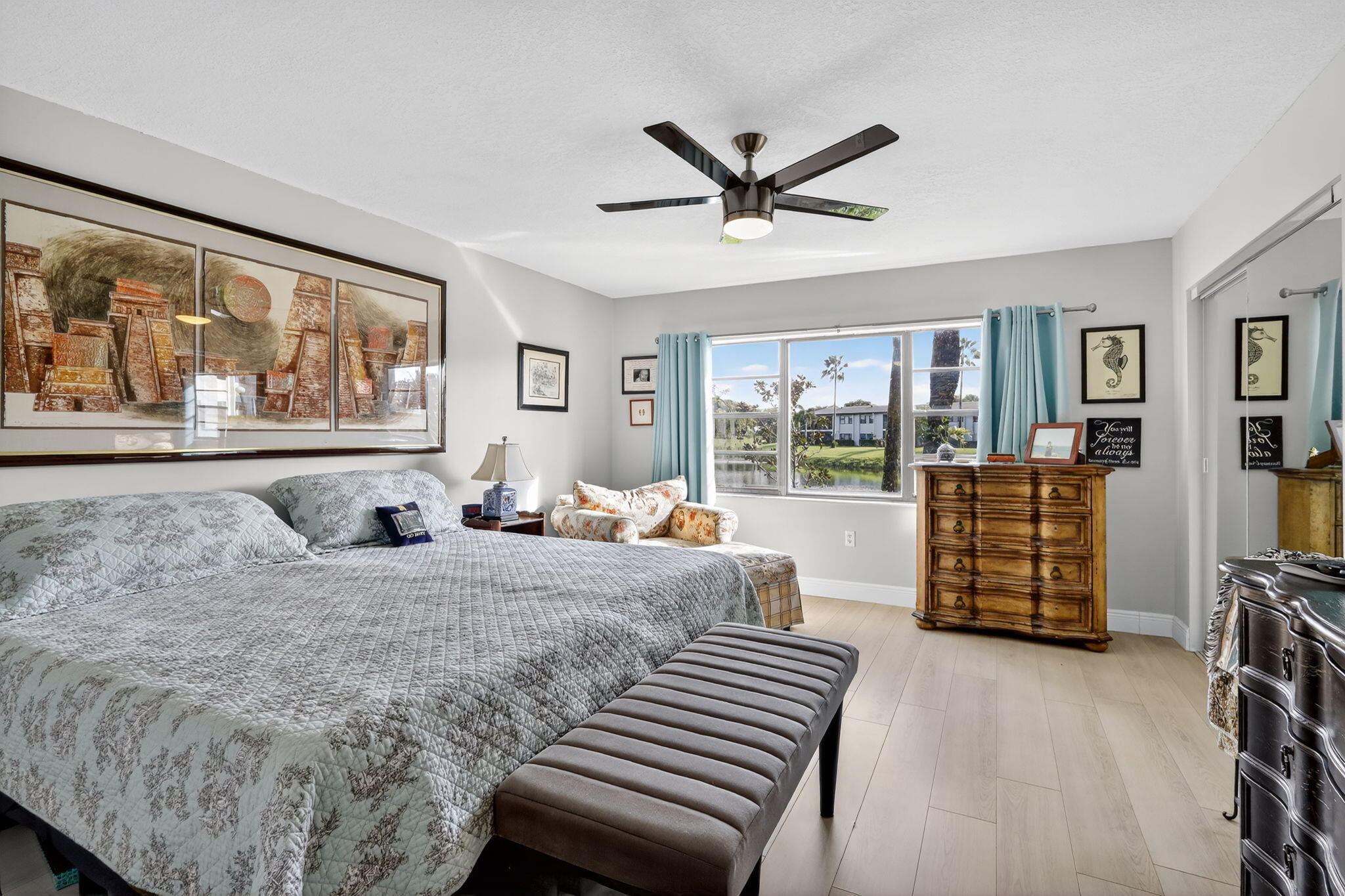 36 Southport Lane, Unit C Boynton Beach, FL 33436 - Photo 11 of 69 a bedroom with a large bed and a flat tv screen