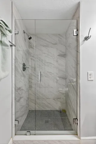 a kitchen with stainless steel appliances kitchen island granite countertop a refrigerator and a stove top oven