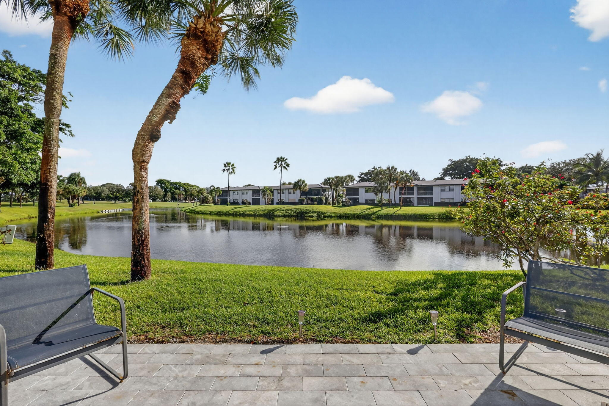 36 Southport Lane, Unit C Boynton Beach, FL 33436 - Photo 40 of 69 a view of a lake with a building in the background