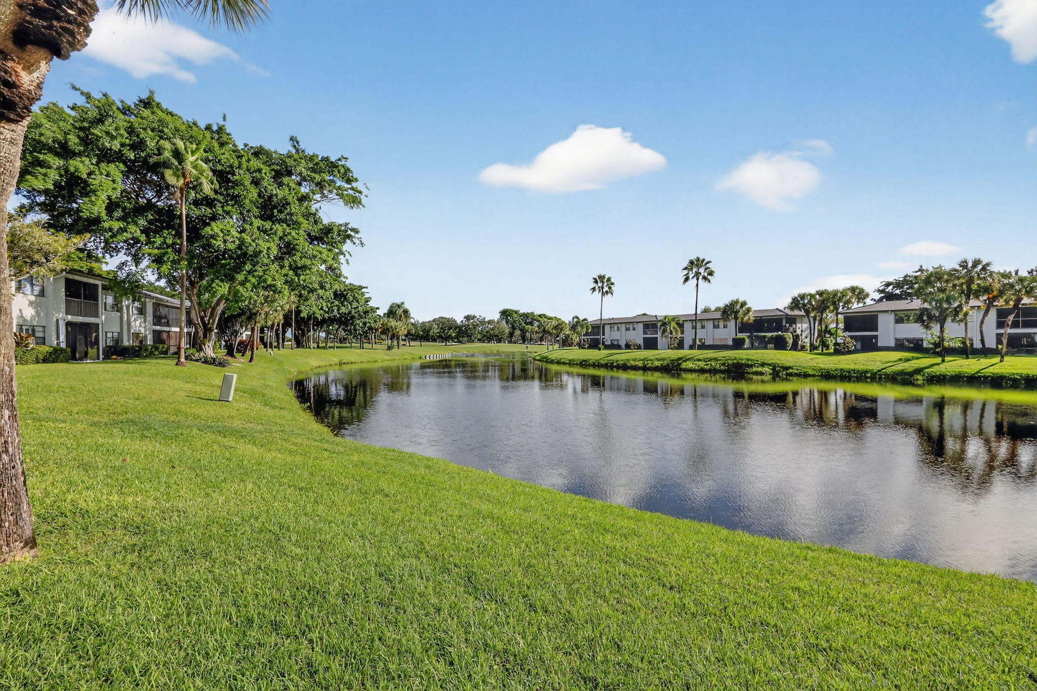 36 Southport Lane, Unit C Boynton Beach, FL 33436 - Photo 41 of 69 a view of a lake with a yard and outdoor seating