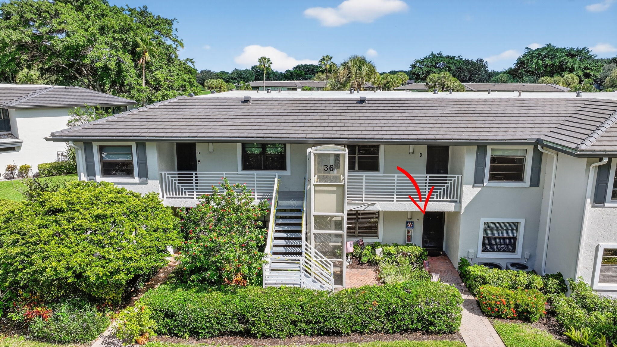 36 Southport Lane, Unit C Boynton Beach, FL 33436 - Photo 49 of 69 a front view of a house with a yard