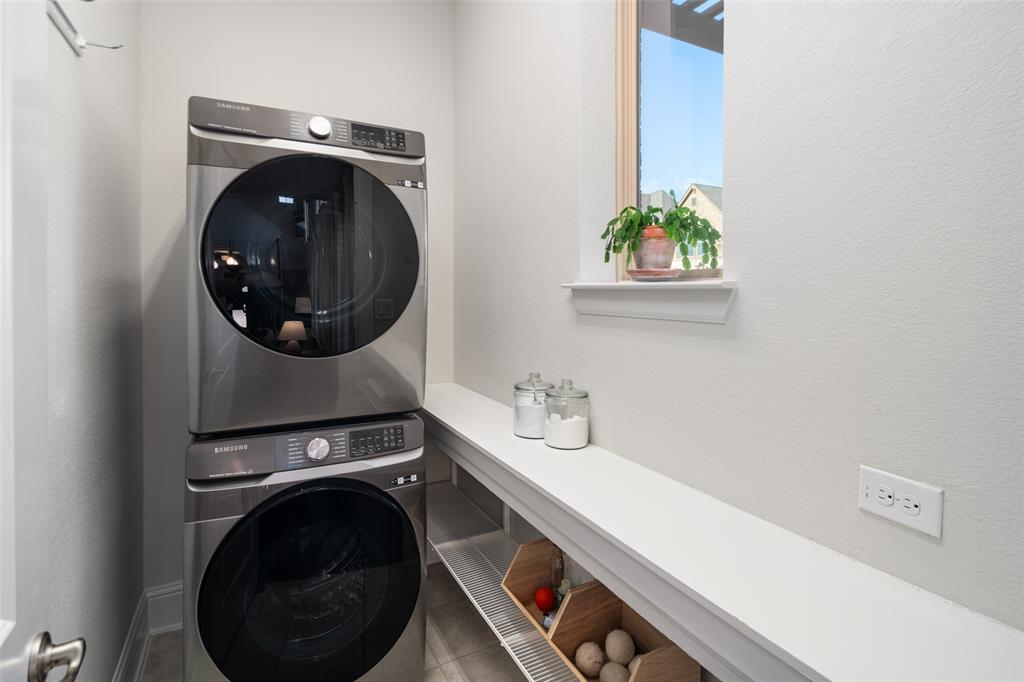 6200 Exeter Avenue McKinney, TX 75070 - Photo 12 of 35 1st floor Laundry room with light filled window and shelving