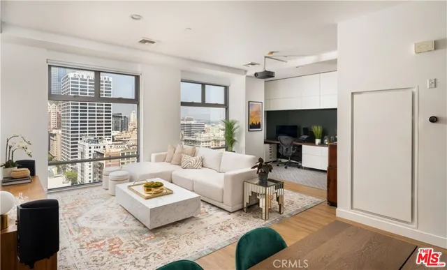a living room with furniture large window and a table