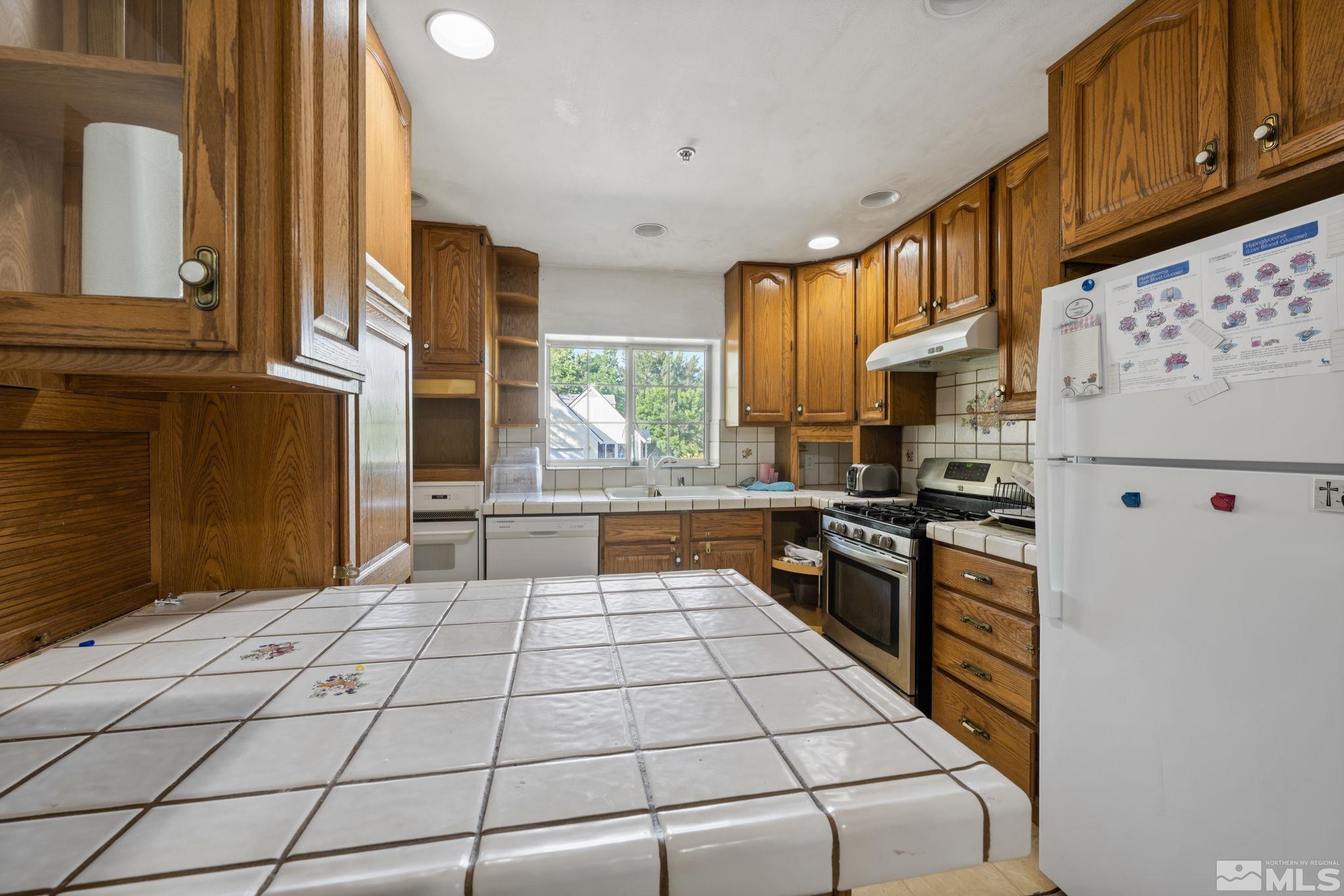 1800 Prince Way Reno, NV 89503 - Photo 14 of 40 a kitchen with stainless steel appliances granite countertop a stove a sink and a microwave
