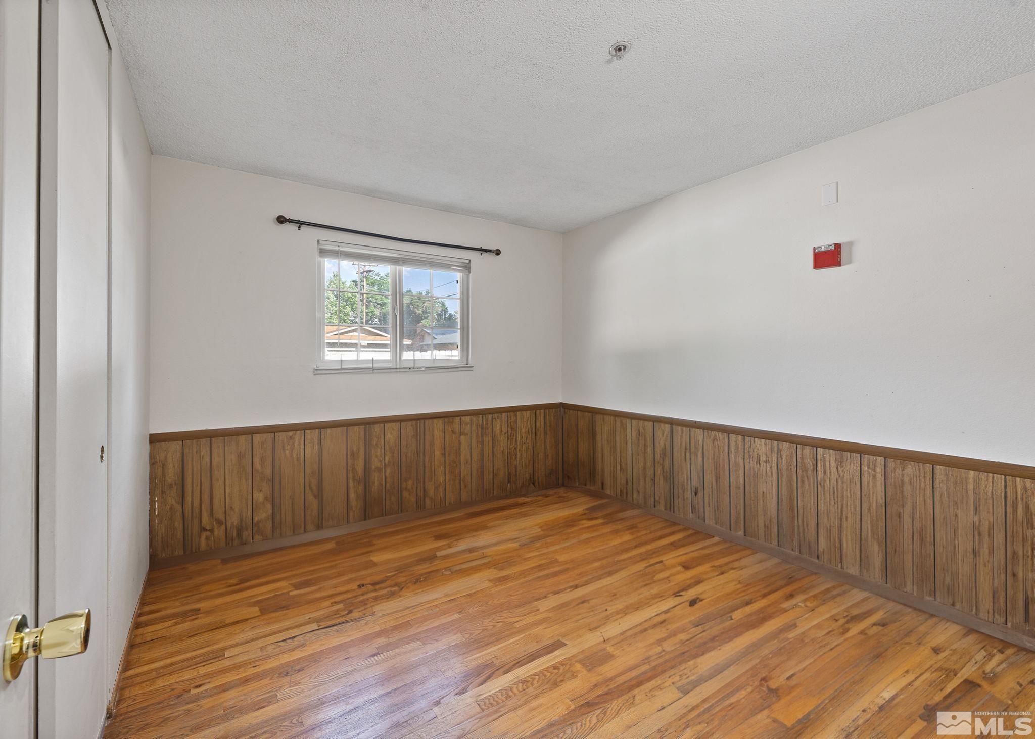 1800 Prince Way Reno, NV 89503 - Photo 25 of 40 an empty room with wooden floor and windows