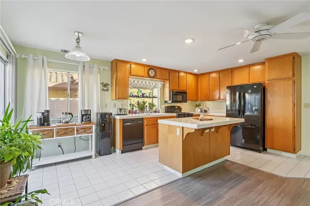 a kitchen with stainless steel appliances granite countertop a stove refrigerator and cabinets