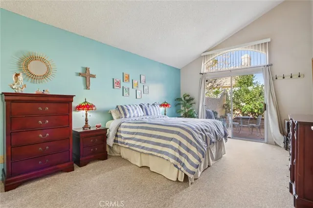 a spacious bedroom with a bed and a window