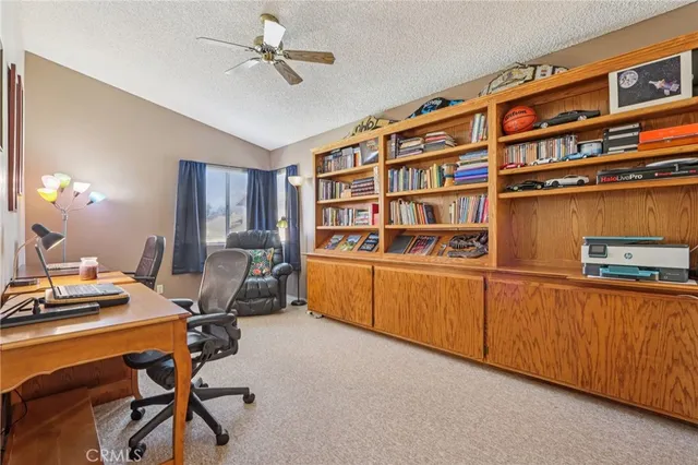 a work room with furniture and a bookshelf