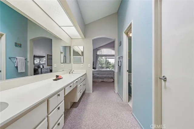 a spacious bathroom with a double vanity sink a mirror and a shower