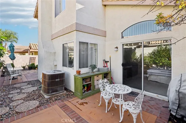 a view of an outdoor dining space with a table and chairs
