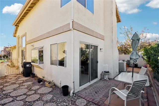 a view of a patio with table and chairs and potted plants