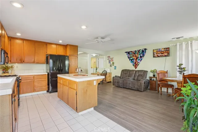 a living room with furniture and a kitchen view