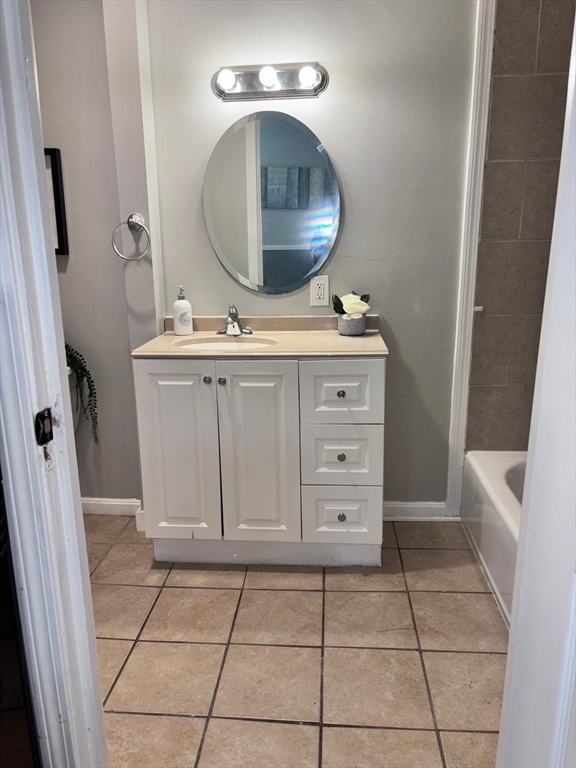 26 Main Street, Unit 2 Spencer, MA 01562 - Photo 11 of 12 a bathroom with a sink a vanity and a mirror