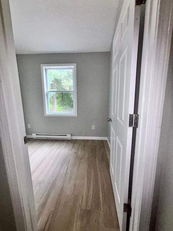 26 Main Street, Unit 2 Spencer, MA 01562 - Photo 3 of 12 a view of a room with wooden floor and window