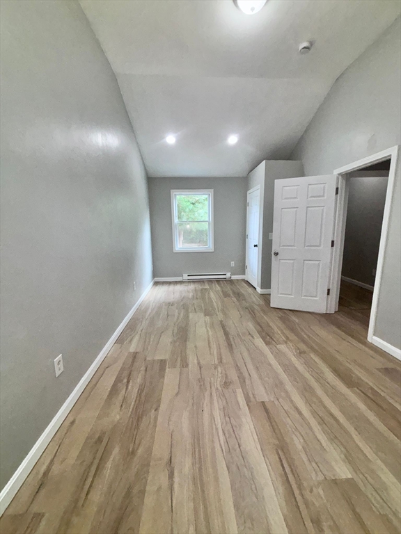 26 Main Street, Unit 2 Spencer, MA 01562 - Photo 4 of 12 an empty room with wooden floor and windows
