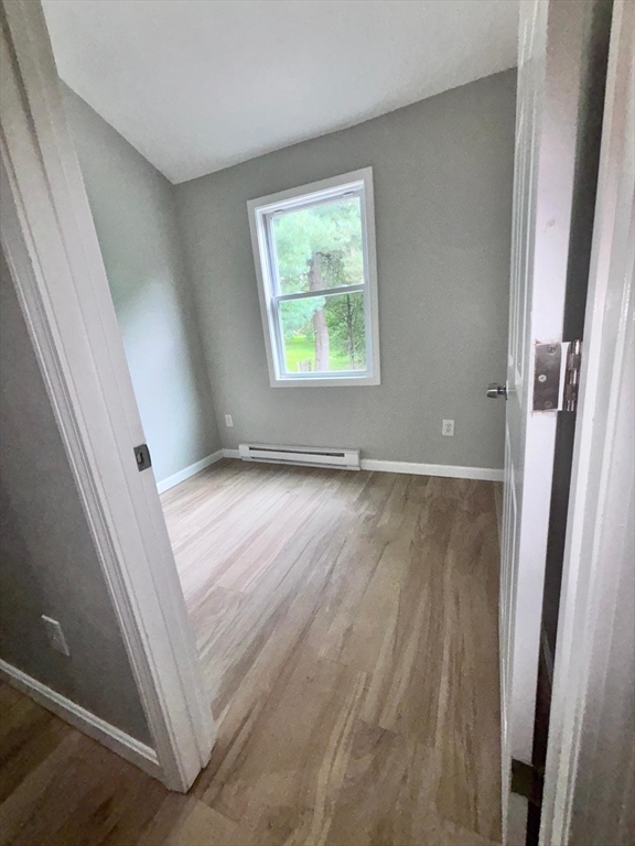 26 Main Street, Unit 2 Spencer, MA 01562 - Photo 5 of 12 an empty room with windows