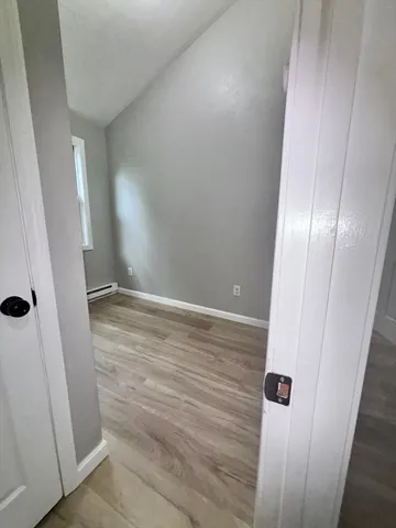 an empty room with wooden floor