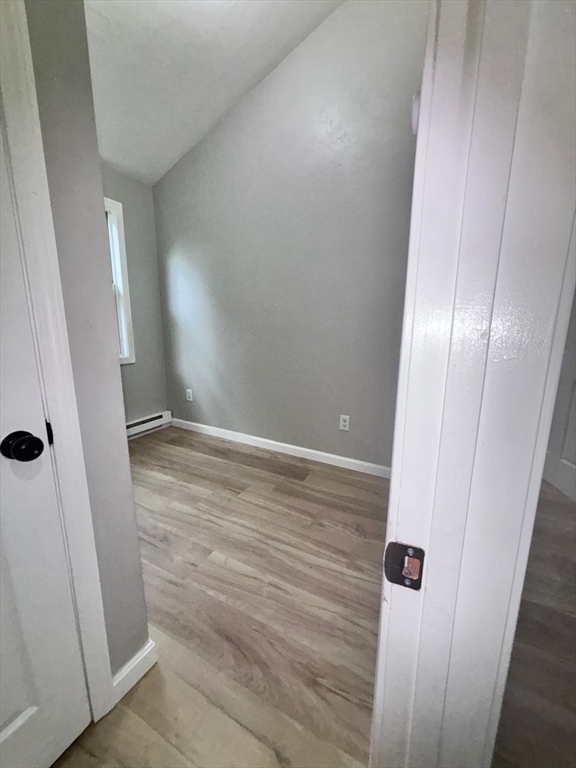 26 Main Street, Unit 2 Spencer, MA 01562 - Photo 6 of 12 an empty room with wooden floor