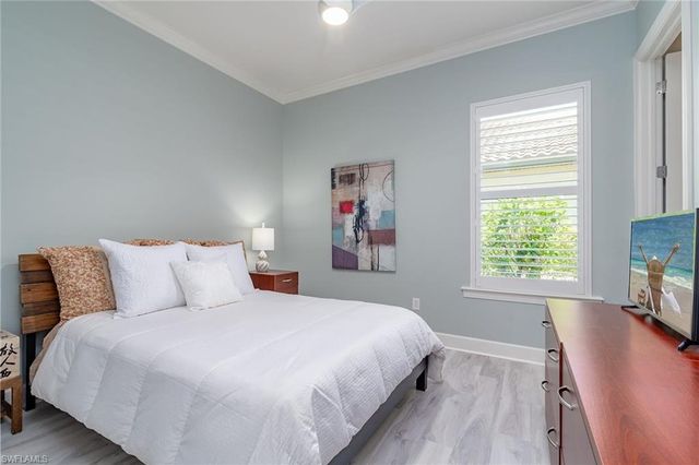 a bedroom with a large bed and a tv on table