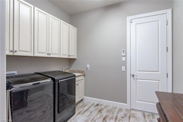 a view of a kitchen with furniture and wooden floor