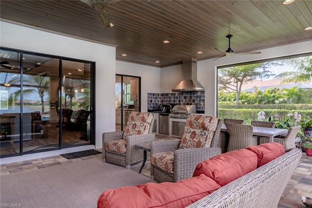 a living room with furniture floor to ceiling window and outdoor view