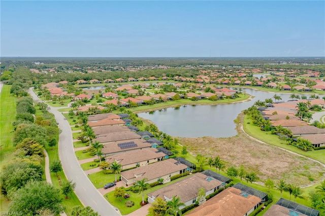 an aerial view of residential building and lake