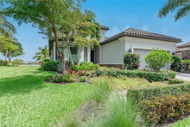 a front view of house with a garden