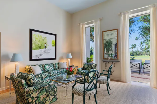a living room with furniture and a painting on the wall