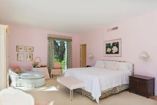 a bedroom with a bed and a large window