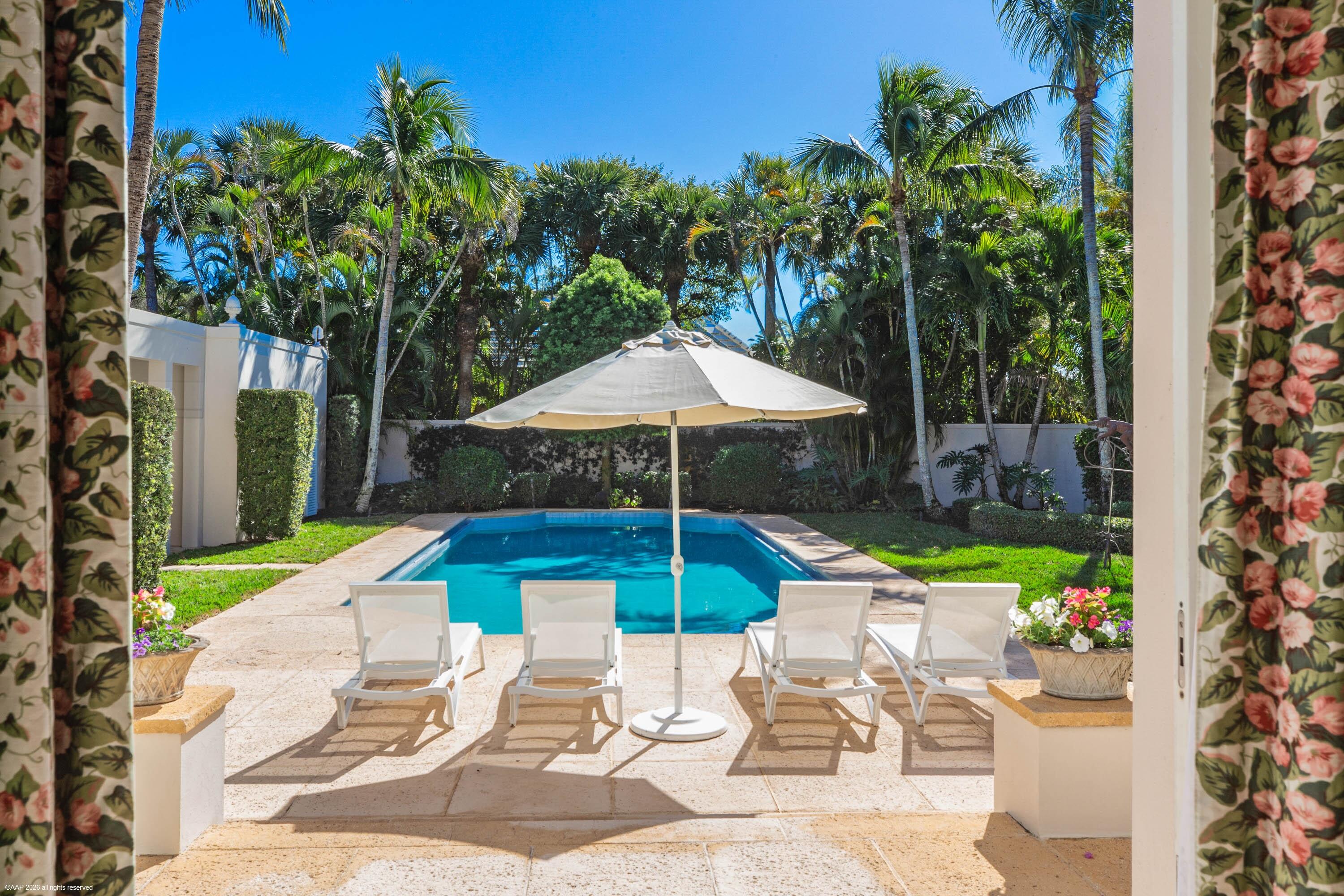 30 Gomez Road Jupiter Island, FL 33455 - Photo 20 of 30 a chair and tables in the patio with a garden