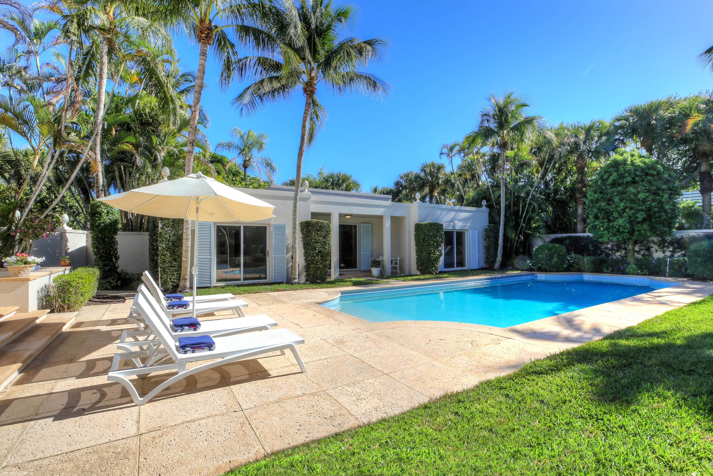 30 Gomez Road Jupiter Island, FL 33455 - Photo 5 of 30 a view of a house with swimming pool and a yard