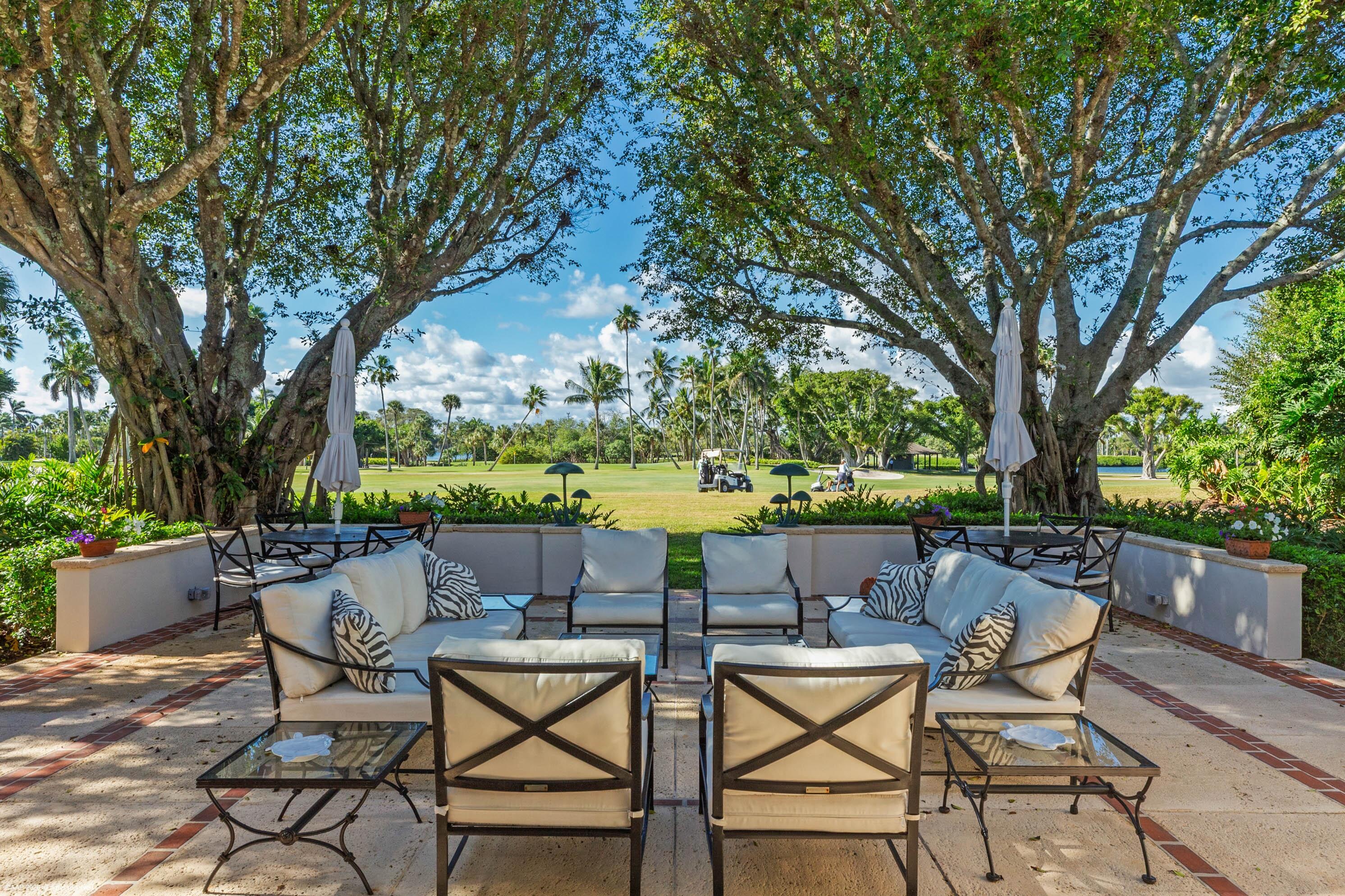 30 Gomez Road Jupiter Island, FL 33455 - Photo 8 of 30 a view of chairs and table in backyard