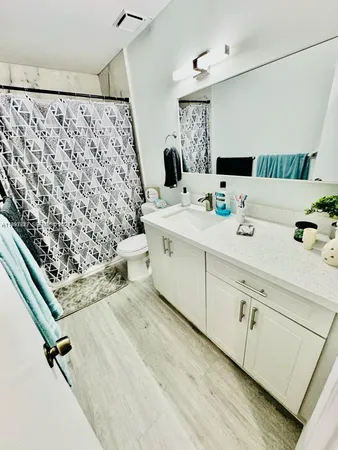 a bathroom with a double vanity sink mirror and shower