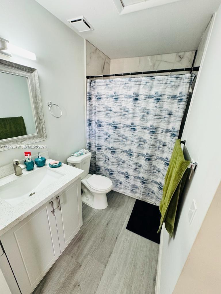 18334 Northwest 68th Avenue, Unit L Hialeah, FL 33015 - Photo 8 of 11 a bathroom with a sink and a mirror