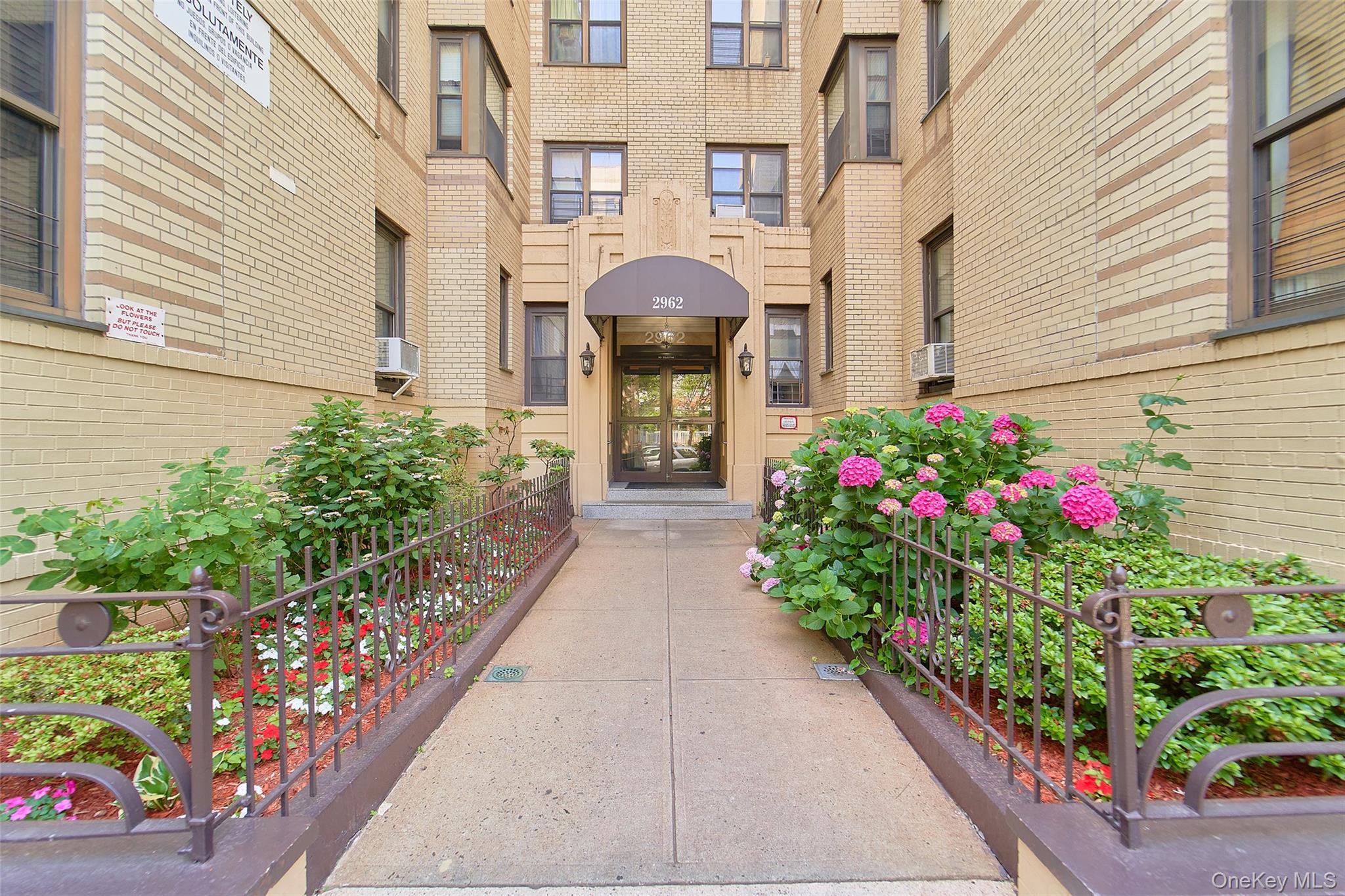 2962 Decatur Avenue, Unit 4D Bronx, NY 10458 - Photo 1 of 21 a front view of a house with lots of flowers and flowers