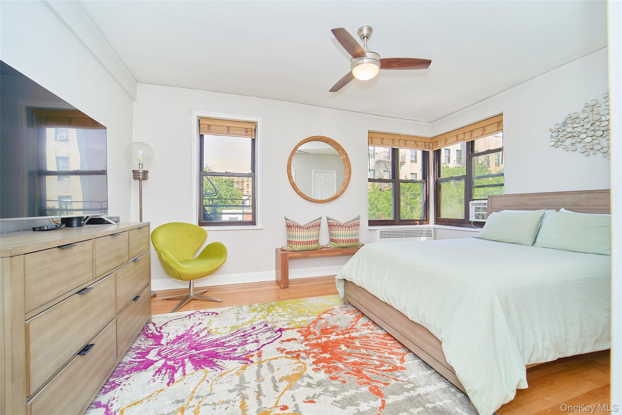 2962 Decatur Avenue, Unit 4D Bronx, NY 10458 - Photo 16 of 21 a bed room with a bed mirror and a window