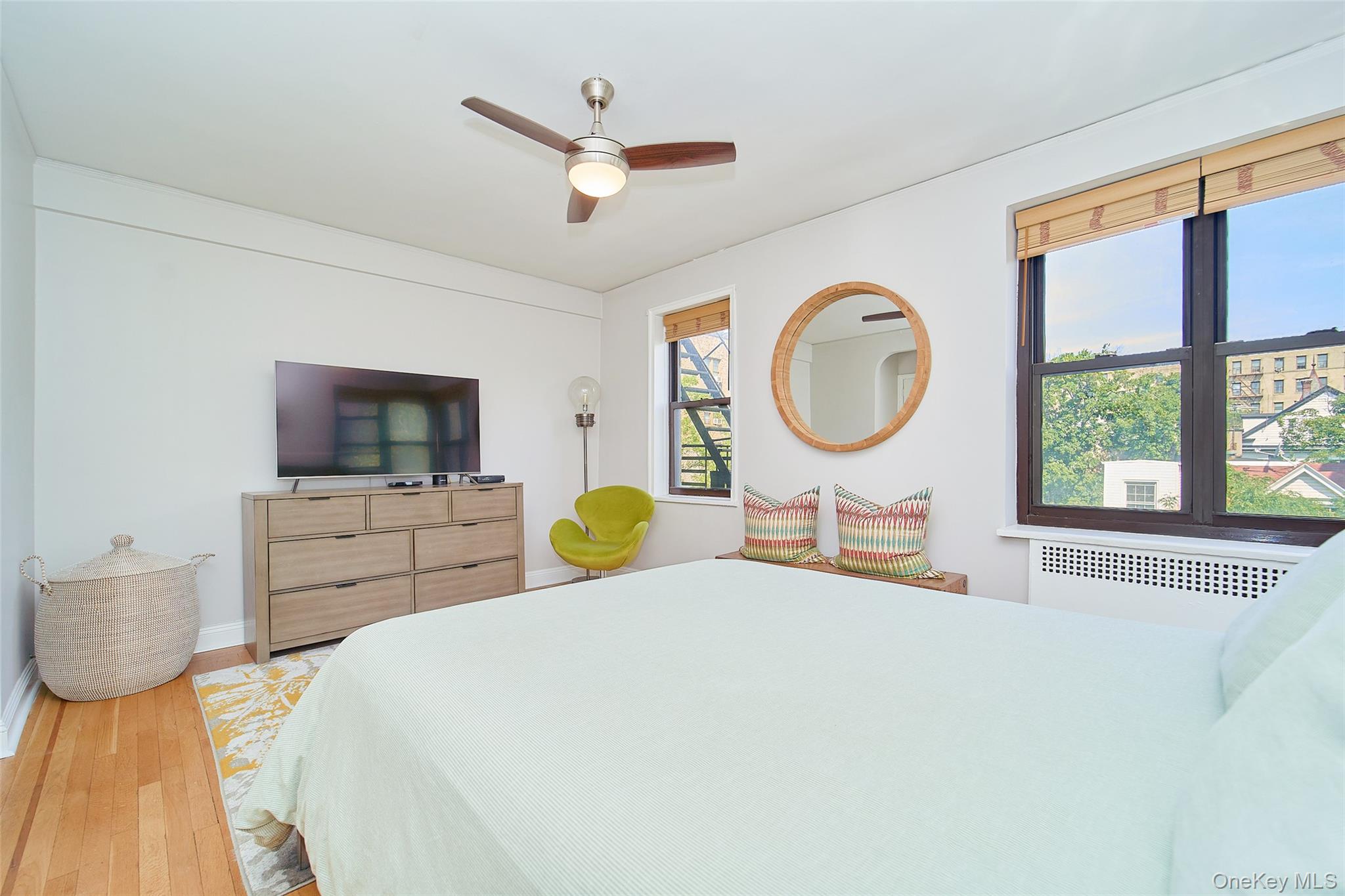 2962 Decatur Avenue, Unit 4D Bronx, NY 10458 - Photo 18 of 21 a bed room with a bed a television and a large window