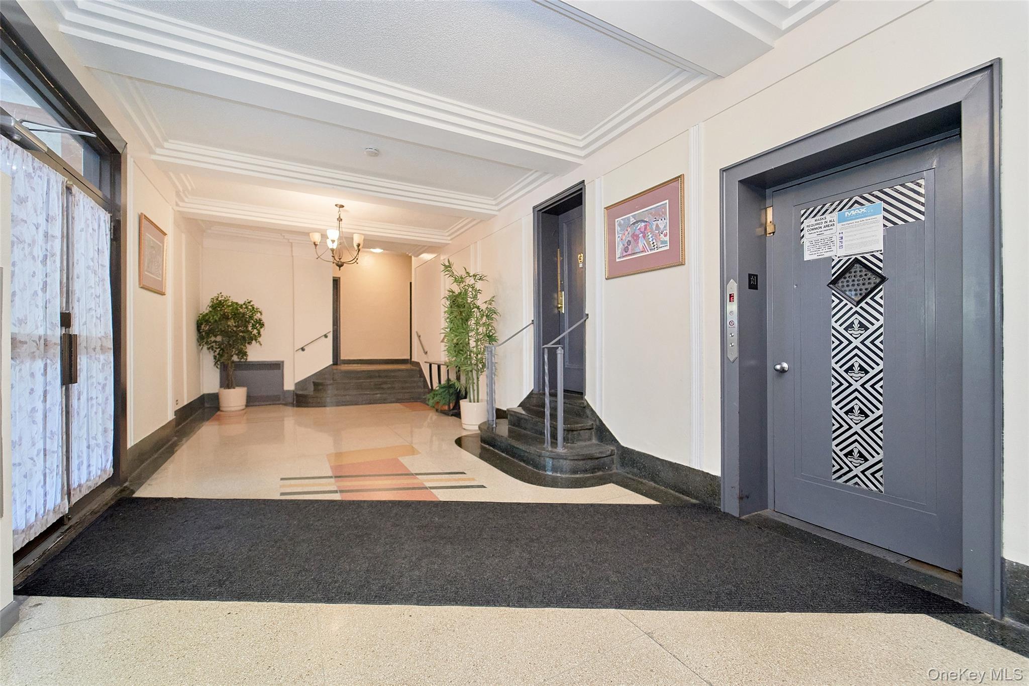 2962 Decatur Avenue, Unit 4D Bronx, NY 10458 - Photo 4 of 21 a living room with a couch and paintings on the wall