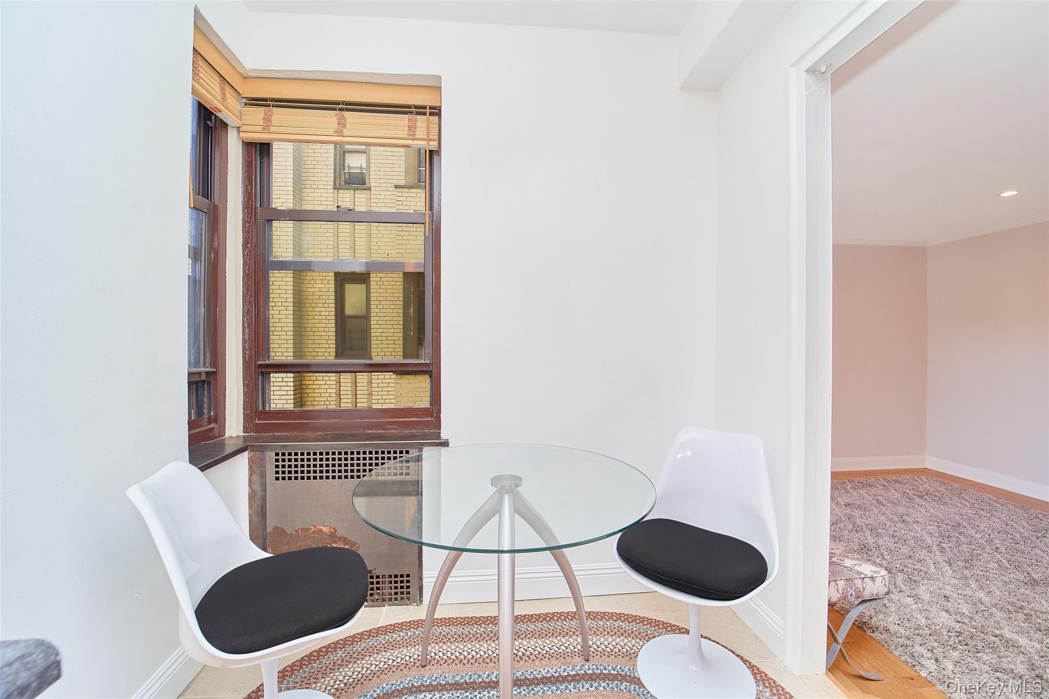 2962 Decatur Avenue, Unit 4D Bronx, NY 10458 - Photo 9 of 21 a dining room with furniture and a window