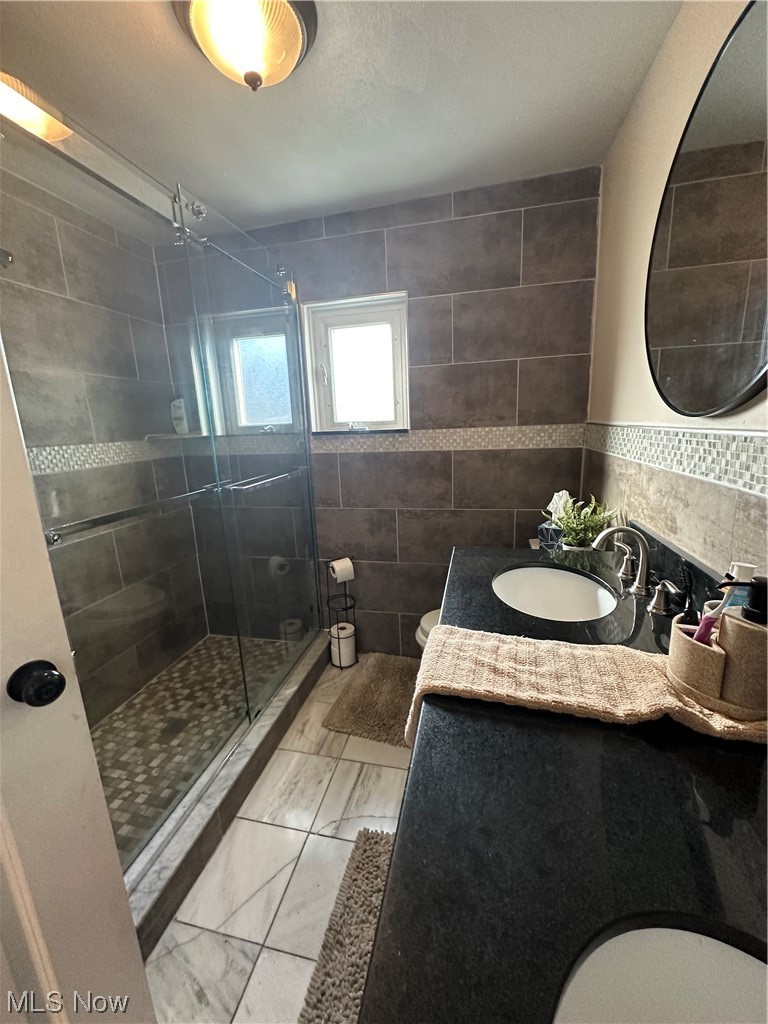 174 Powers Road Weirton, WV 26062 - Photo 33 of 33 Bathroom featuring an enclosed shower, vanity, toilet, tasteful backsplash, and tile walls