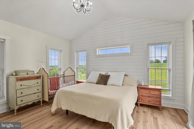 a bedroom with a bed and a large window